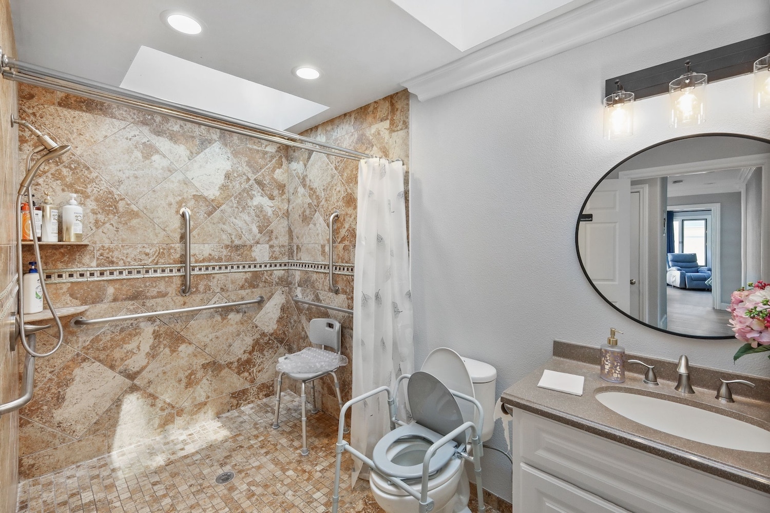 Accessible bathroom with walk-in shower, grab bars, shower chair, and safety features for seniors or disabled individuals.